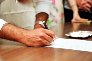 A homeowner signing a deed in front of a notary
